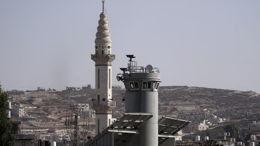 An Israeli military guard tower with two robotic guns and surveillance cameras at the Aroub refugee camp in the West Bank, Thursday, Oct. 6, 2022 