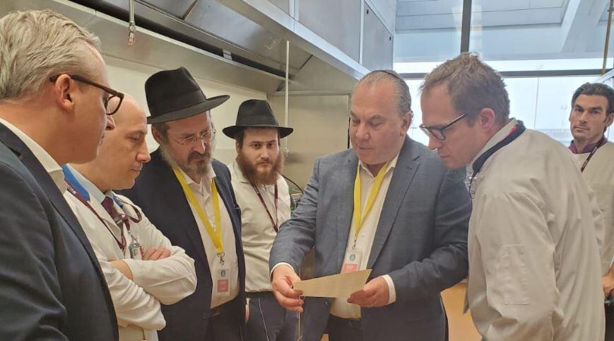 Rabbi Marc Schneier, holding paper, and Rabbi Mendy Chitrik, third from left, worked together on the initiative