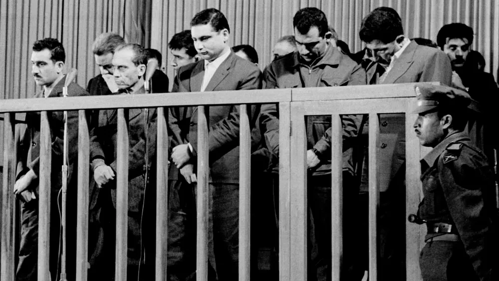 Elie Cohen, far left, head of an Israeli spy ring, listens as he is sentenced to death by a special military court in Damascus, Syria, May 8, 1965 