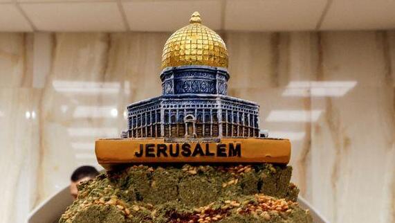 A depiction of the Dome of the Rock rests on a tower of zaatar at a spice stall in a market, Jerusalem's Old City, December 11, 2022  