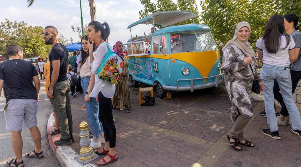 Tourists explore the streets of Ghajar, Oct. 14, 2022