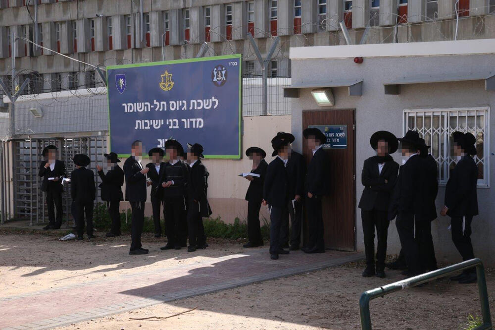 Ultra-Orthodox men outside an IDF recruitment center 