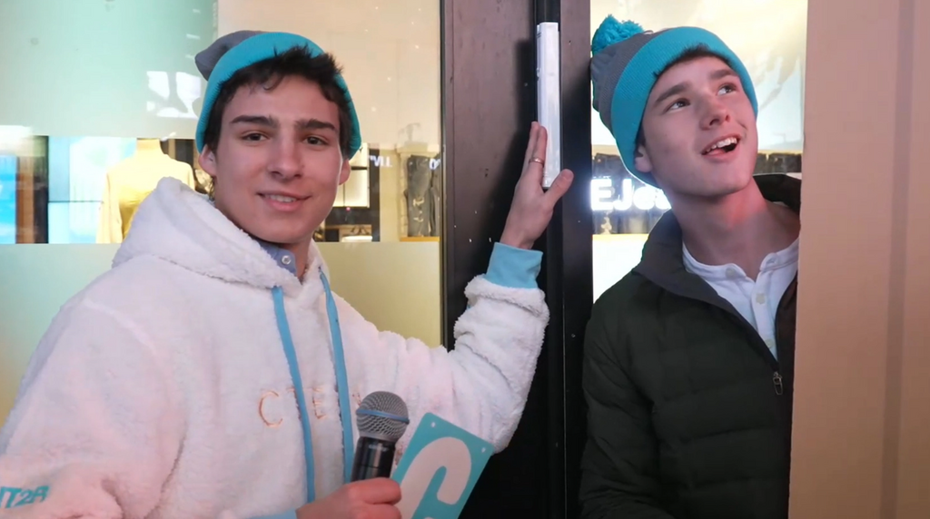 Attendees of a Chabad teen convention in Times Square pose next to the mezuzah affixed to the doorpost of American Eagle Outfitters' flagship store 