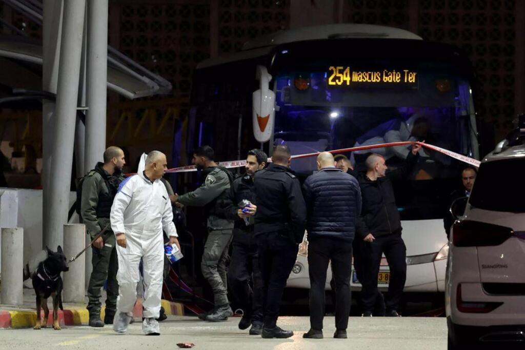 Israeli security forces gather at a checkpoint at the entrance to east Jerusalem's Shuafat refugee camp following a stabbing attack on February 13, 2023 