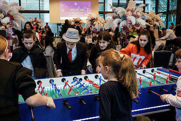 Children related to Chabad Berlin Jewish community play table football during Purim Holiday in Berlin, Germany, 07 March 2023