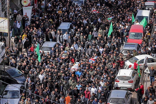 Mourners march with the bodies of Palestinians killed the previous day in an Israeli army raid in the Jenin camp for Palestinian refugees, during their funeral in the camp on March 8, 2023.
