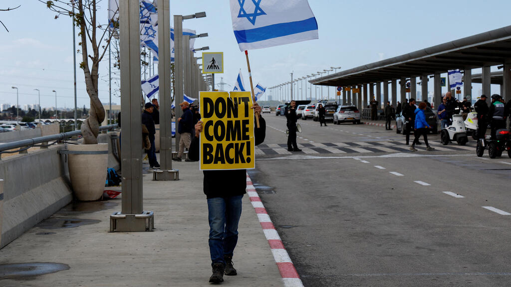 A protester demonstrates at Ben Gurion International Airport where Israelis attempt to disrupt the departure of Israeli Prime Minister Benjamin Netanyahu to Berlin
