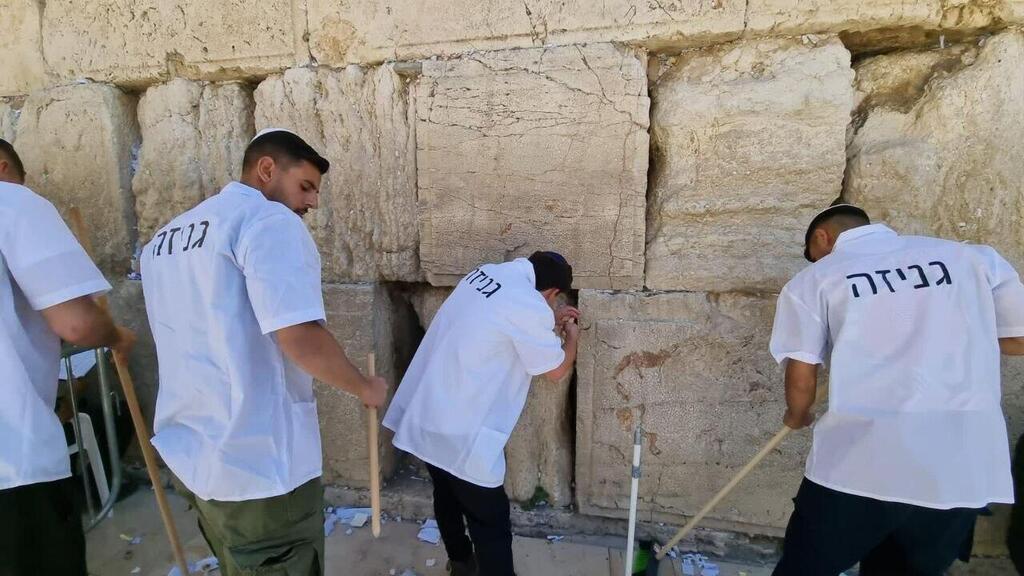 Cleaning the Western Wall before Passover