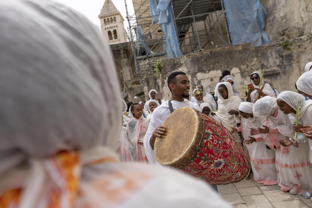 Ethiopian Orthodox Christian worshippers gather for Palm Sunday celebrations at the Ethiopian monks' quarters on the rooftop of the Church of the Holy Sepulcher, the place where Christians believe Jesus Christ was crucified, buried and resurrected, in Jerusalem, Sunday, April 9, 2023 