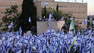 Pro-government protesters wave the Israeli flag 