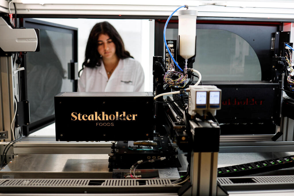 A 3D printer forms a piece of cultivated grouper fish at the offices of Steakholder Foods in Rehovot