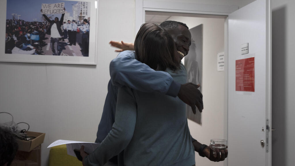 Omer Easa hugs Sigal Rozen at the offices of the Hotline for Migrant Workers 