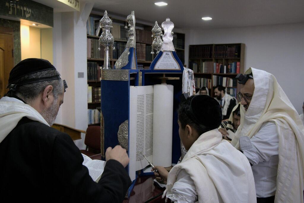A bar mitzvah boy reads from the Torah at Bello Synagogue, April 24, 2023 