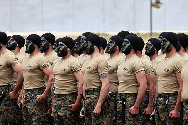 Lebanese Hezbollah fighters parade during a press tour in the southern Lebanese village of Aaramta, on May 21, 2023, ahead of the anniversary of the Israeli withdrawal from Lebanon