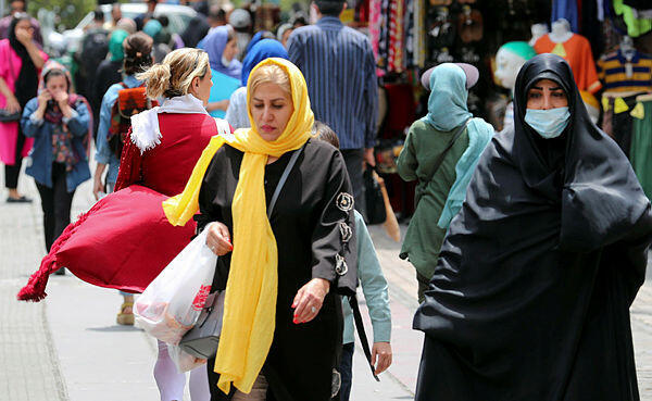Iranian women, wearing a veil, walks among other pedestrians along a street in Tehran, Iran, 22 May 2023