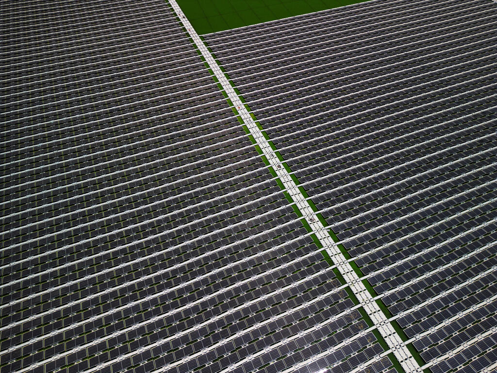 An aerial view shows solar panels on a water reservoir 