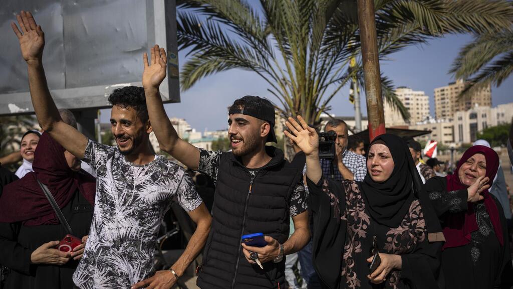 Relatives of Huda Zaqqout wave to say goodbye as she leaves Gaza City for the Hajj pilgrimage in the holy city of Mecca 