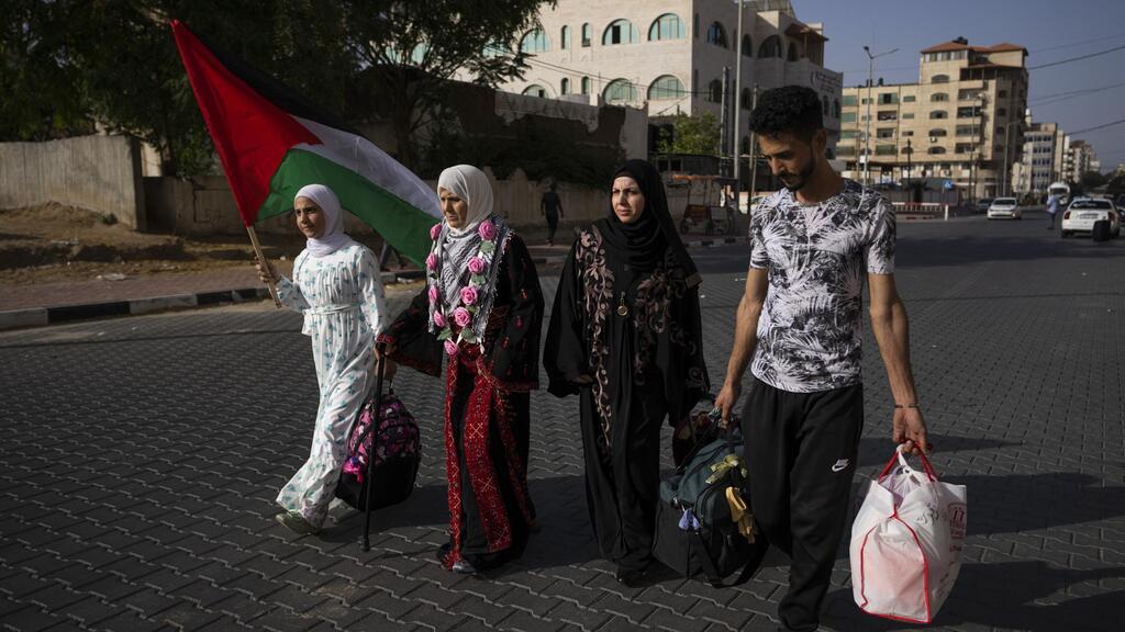 Huda Zaqqout, second left, walks with her relatives as she leaves Gaza City for the Hajj pilgrimage in Mecca 