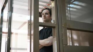 US journalist Evan Gershkovich stands inside a defendants' cage at Moscow City Court 