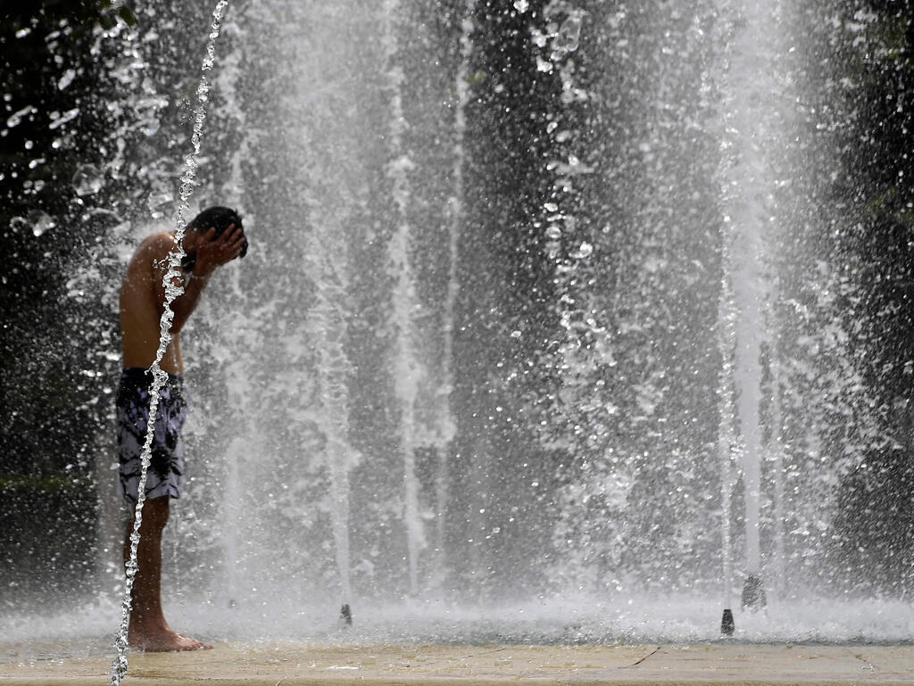 מתקררים בסביליה בדרום ספרד (צילום: CRISTINA QUICLER / AFP) גל חום דרום אירופה סביליה ספרד