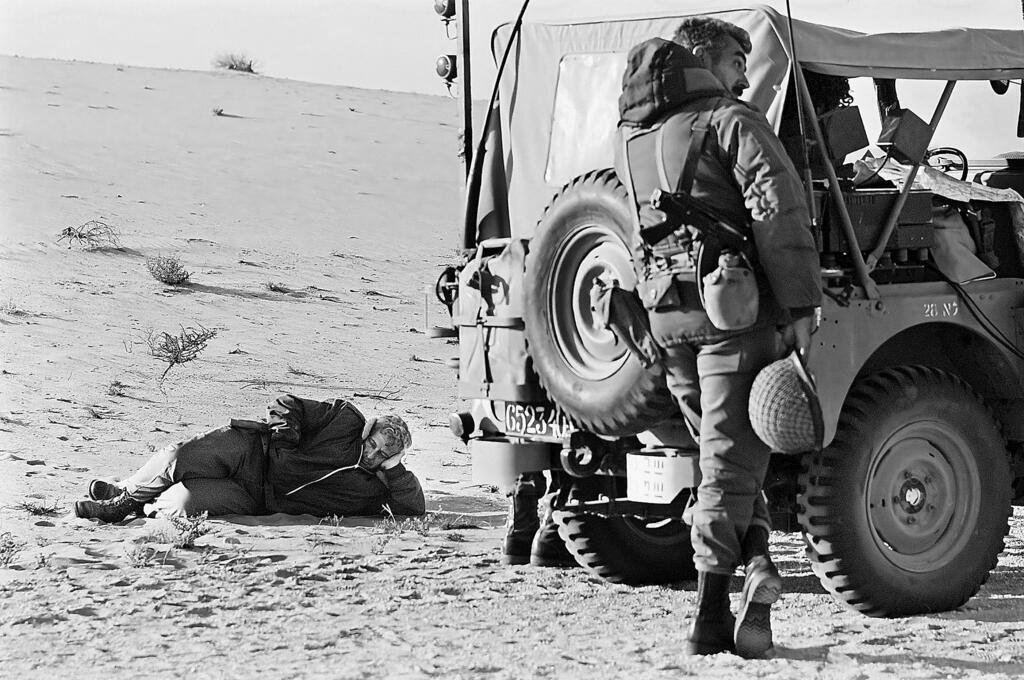 Ariel Sharon resting his head on the sand 