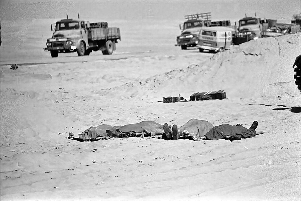 Bodies of Israeli soldiers lying on the ground covered in blankets 