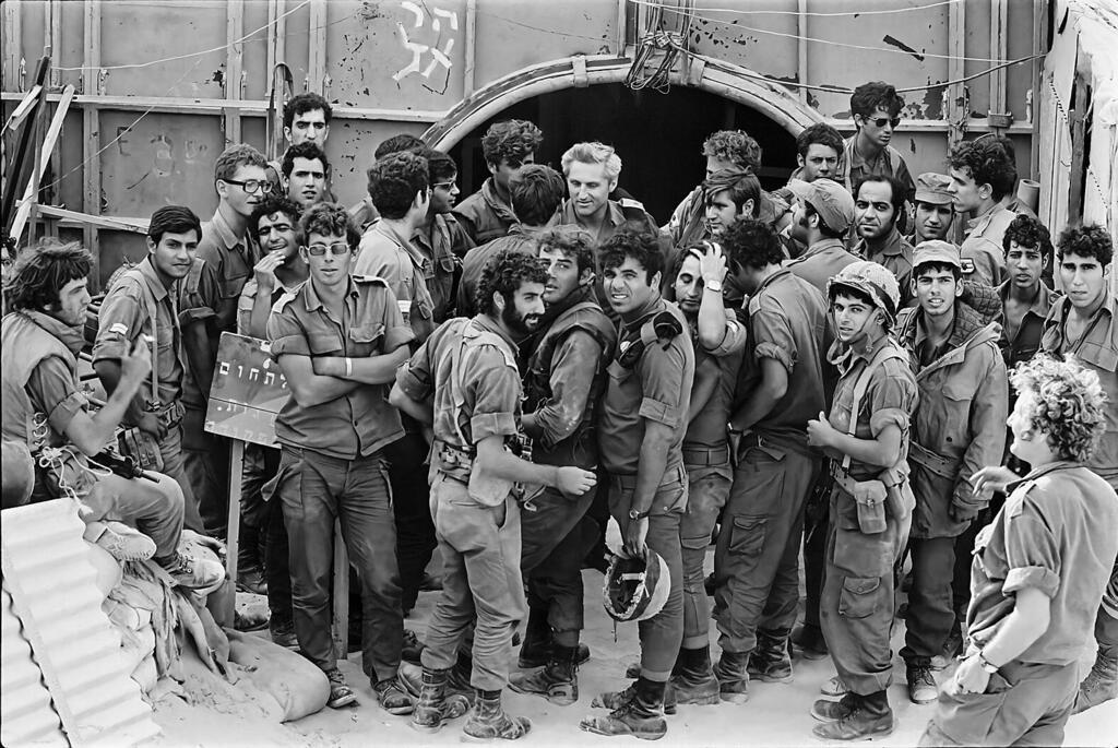 Soldiers clammoring to get their picture taken with Chich 