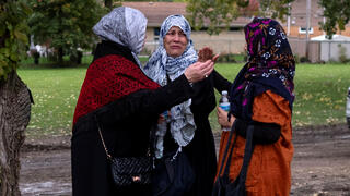 Mourners arrive at Parkholm Cemetery to attend the burial of Wadea Al-Fayoume, 6, a Muslim boy who according to police was stabbed to death in an attack that targeted him and his mother for their religion