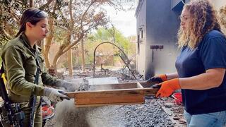 ארכיאולוגית וחיילת מנפות אפר בניסיון למצוא שרידי אדם, קיבוץ בארי