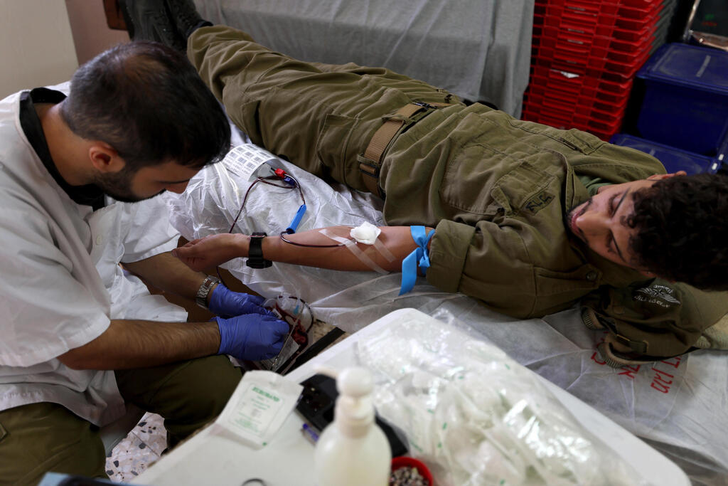 An Israeli donates blood at Magen David Adom center in Kibbutz Mahanaim, northern Israel, Oct. 29, 2023 