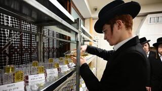 Erlau Yeshiva students light Hanukkah menorahs for hostages 
