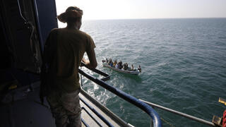 Houthi fighter keeps watch on the deck of the Galaxy Leader cargo ship, seized by the Houthis earlier this month 