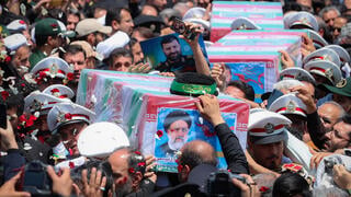 Mourners carry the coffin of late Iranian President Ebrahim Raisi, during his burial ceremony in Mashhad