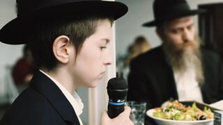 Boy recites prayer during bar mitzvah celebration in Odessa, Ukraine 