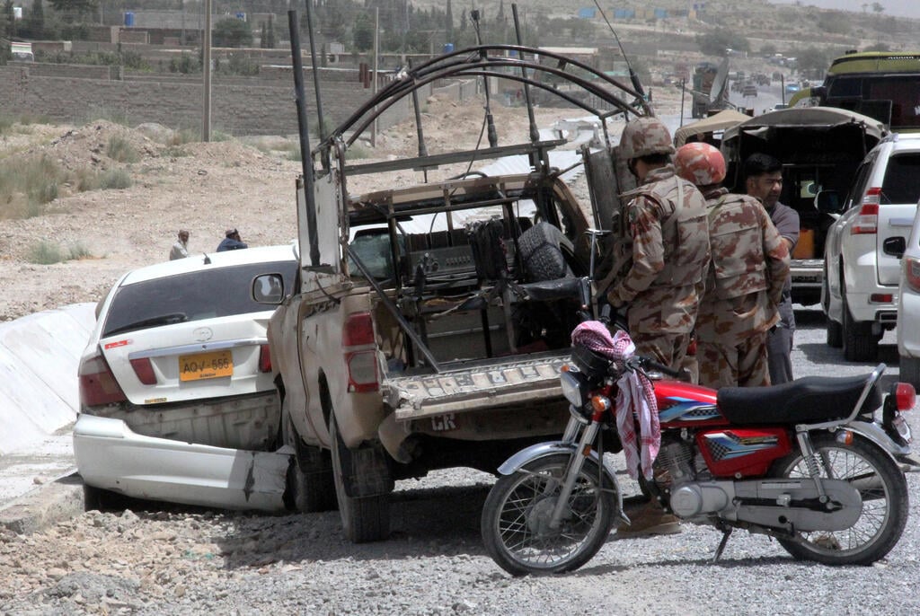 Pakistani security officials inspect the scene of a blast near a Frontier Corps vehicle on a roadside in Quetta, the provincial capital of the Balochistan province, Pakistan, on July 13, 2024. According to police, an explosive device planted by unknown suspected terrorists in the Akhtar Abad area near the Western Bypass in Quetta exploded and killed at least one person and injured two others.