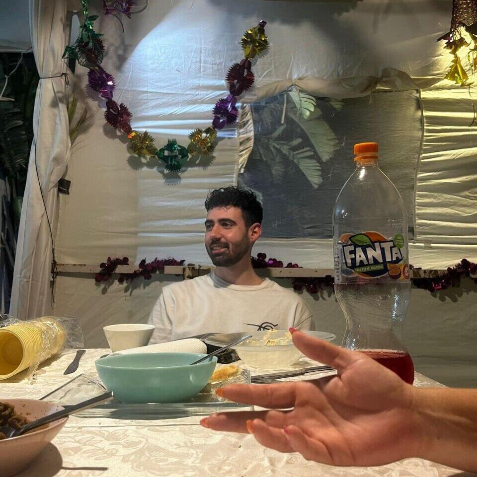 Guy Gilboa-Dalal in the family sukkah before his abduction to Gaza (Photo: Courtesy of the family) גיא גלבוע דלאל בחג בשנה שעברה