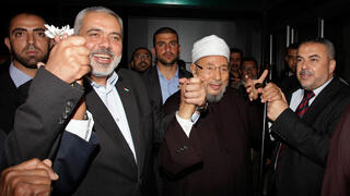Abdul Rahman Al-Qaradawi (middle) with Hamas officials 