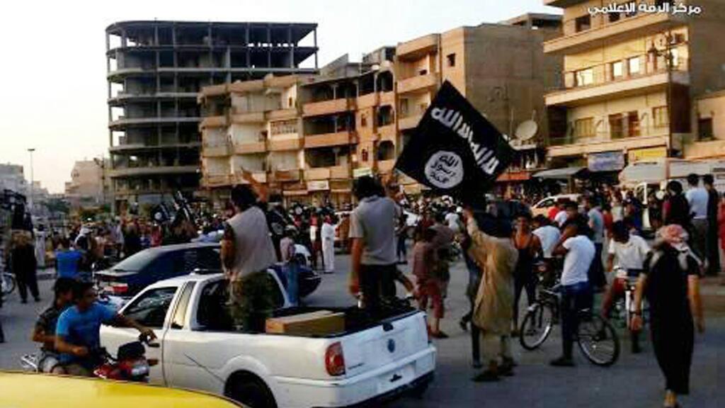 A flag of the Islamic State in northern Syria in 2014