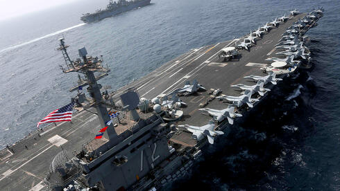 US aircraft carrier still en route to Middle East as Trump declines to say if Iran would face strike