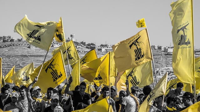 Hezbollah supporters flying the terrorist group's flags (Photo: Shutterstock) Hezbollah supporters flying the terrorist group's flags