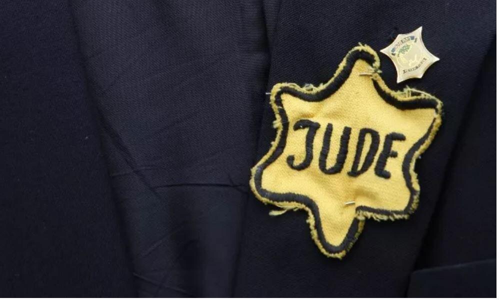 A jacket belonging to the late Polish-born Holocaust survivor Mordechai Fuchs emblazoned with a yellow star badge with the word 'Jew' in German inscribed on it (Photo: AFP) A jacket belonging to the late Polish-born Holocaust survivor Mordechai Fuchs