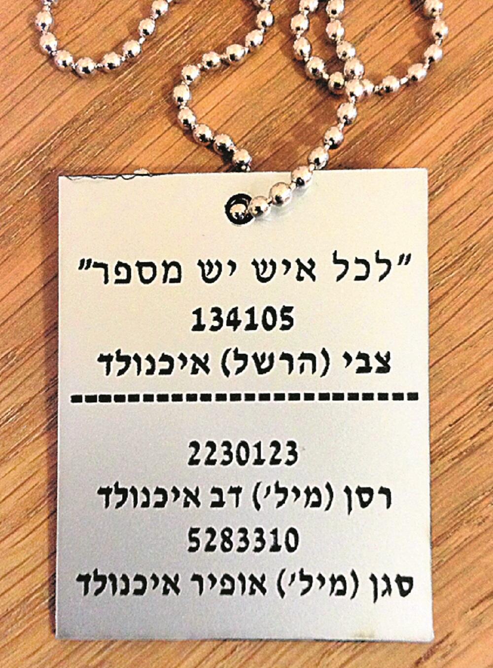 The silver dog tag includes numbers of the tattoo on Zvi Eichenwald's arm and IDF personal ID of Dovi and Ofir (Photo: private album) המספר על הזרוע של צבי איכנולד והמספרים האישיים של דובי ואופיר בצה"ל