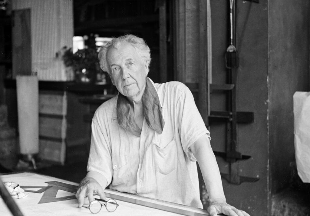 Wright at his drafting table. He designed more than 1,000 buildings, about 530 of which were built (Photo: AP) פרנק לויד רייט