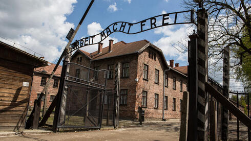 Replica of Auschwitz gate, swastikas placed outside German tax office