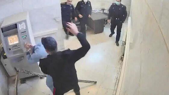 A frame grab taken from video shows a guard beating a prisoner at Evin prison in Tehran, Iran