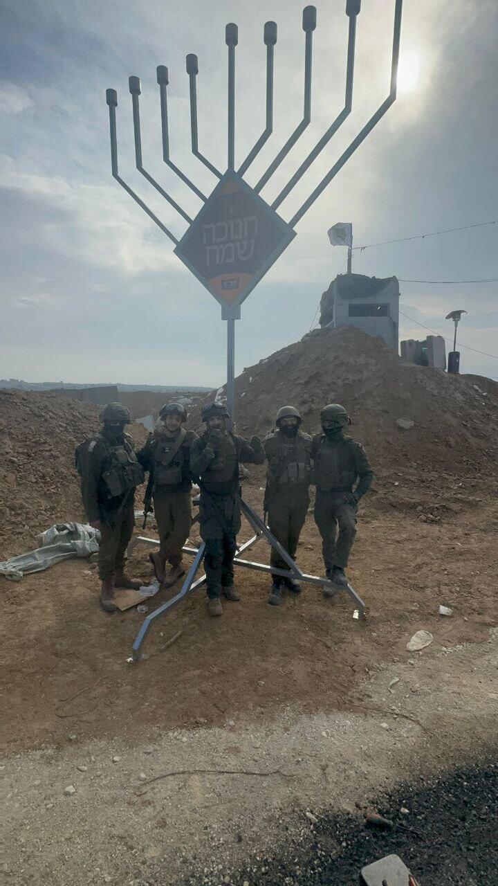 IDF Soldiers Next to a Giant Menorah in the Gaza Strip (Photo: Courtesy of Chabad) חיילי צה"ל מדליקים חנוכיית ברצועת עזה