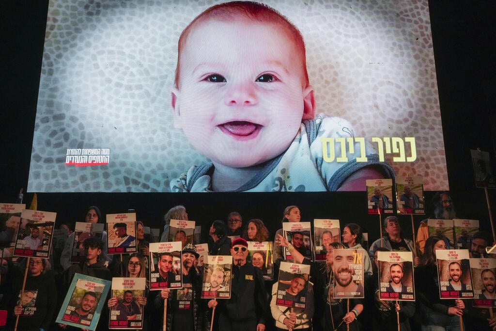 Tel Aviv rally calling for release of hostages; in the background: image of Kfir Bibas displayed on screen (Photo: AP Photo/Ohad Zwigenberg) הפגנה בתל אביב