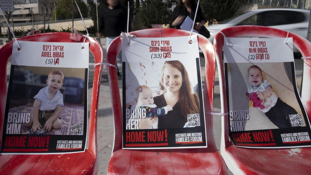 Posters calling for the return of Shir, Ariel and Kfir Bibas (Photo: AP Photo/Maya Alleruzzo) כסאות עם תמותיהם של שירי, כפיר ואריאל ביבס בירושלים