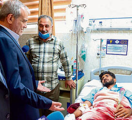 נשיא איראן לצד אחד הפצועים | צילום: AFP yk14349702