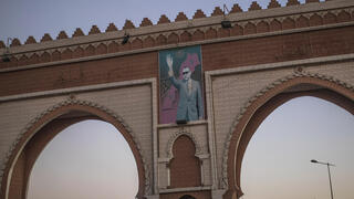 An archway in the entrance of Dakhla carries an image of Morocco